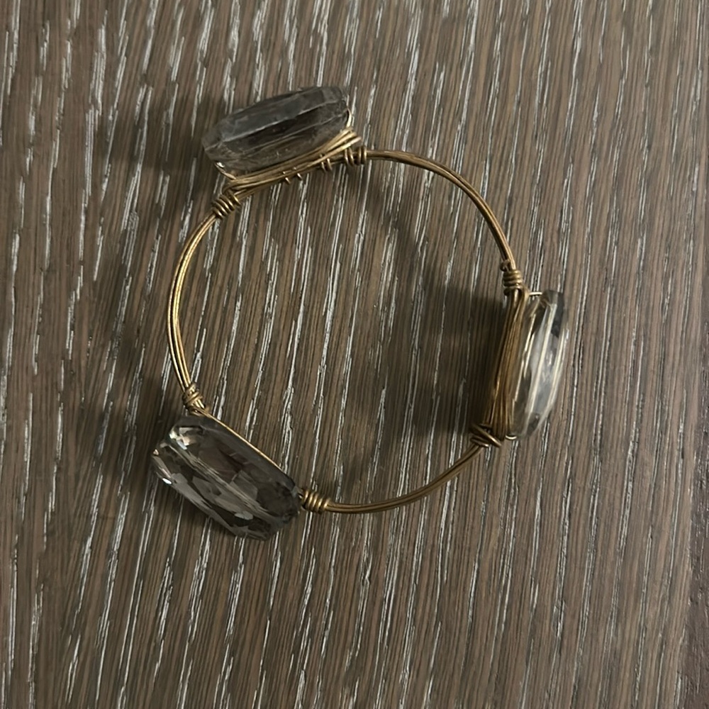 Gold colored wire bangle with three faux clear/grey jewels